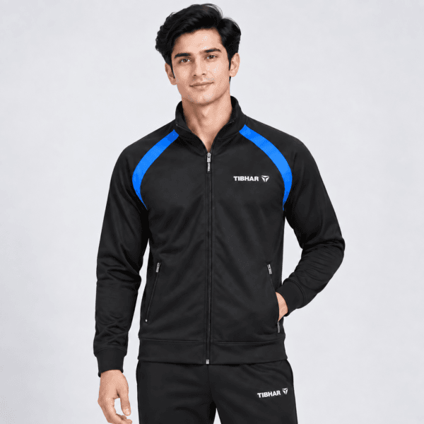 Tibhar raglan training jacket in black with blue shoulder panel, full zip, worn by model