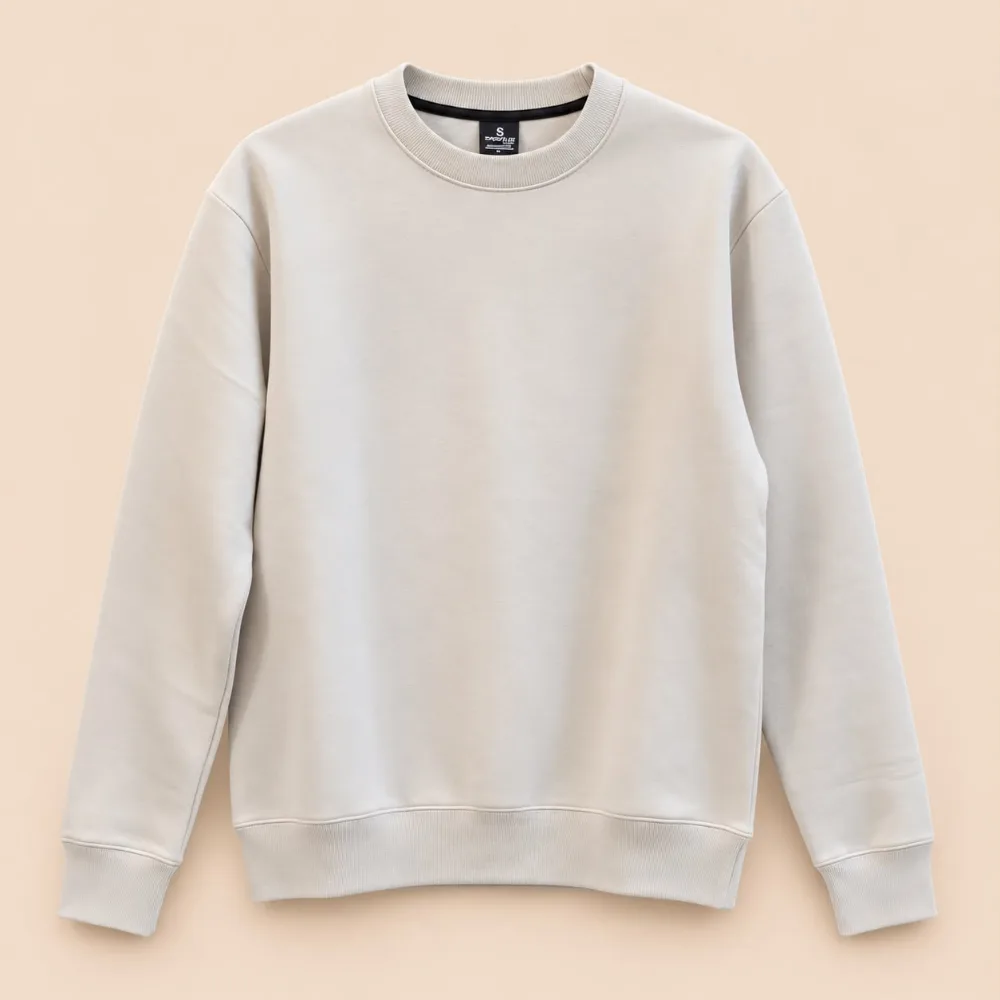 Sportlux Plus beige crewneck sweatshirt front Sportlux Plus beige crewneck sweatshirt, plain front, fine-knit rib collar, cuffs and waistband, flat lay on a light background