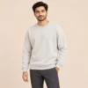 Man wearing the Sportlux Plus beige crewneck sweatshirt with charcoal trousers, regular fit, front view