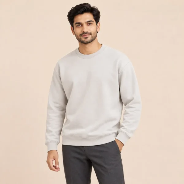 Man wearing the Sportlux Plus beige crewneck sweatshirt with charcoal trousers, regular fit, front view