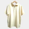 Sportlux Plus beige quarter zip polo photographed on a hanger, front view showing the real fabric, off-white embroidered S and SPORTLUX PLUS neck label