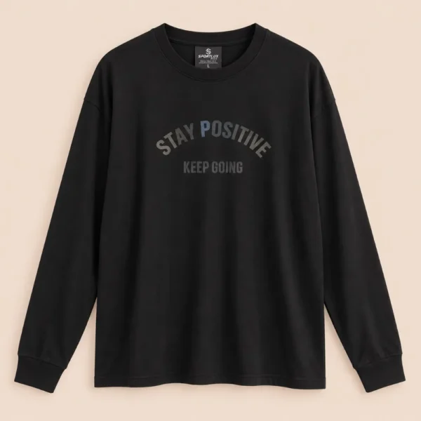 Sportlux Plus black oversized full sleeve t-shirt with tonal STAY POSITIVE KEEP GOING chest print, drop shoulder, rib collar and cuffs, flat lay