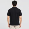Back view of a man wearing the Sportlux Plus black quarter zip polo, plain back, ribbed sleeve bands and side vents at the hem