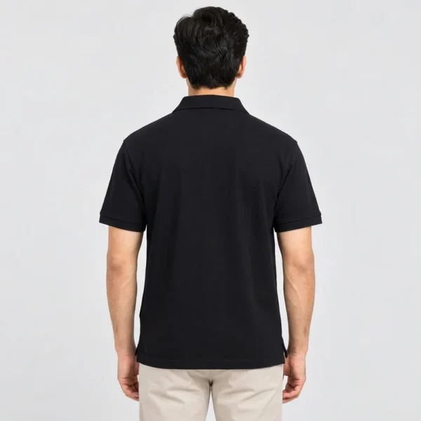 Back view of a man wearing the Sportlux Plus black quarter zip polo, plain back, ribbed sleeve bands and side vents at the hem