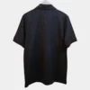 Sportlux Plus black quarter zip polo photographed on a hanger, back view showing the real fabric, ribbed sleeve bands and side vents