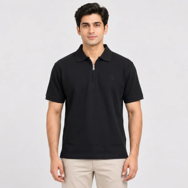 Man wearing a Sportlux Plus black quarter zip polo in fine cotton pique, front view, silver metal zip and tonal black embroidered S on the left chest