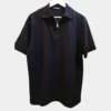 Sportlux Plus black quarter zip polo photographed on a hanger, front view showing the real fabric, tonal black embroidered S and SPORTLUX PLUS neck label
