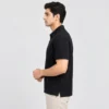 Side view of the Sportlux Plus black quarter zip polo showing the regular fit, sleeve length and open side vent at the hem