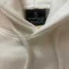Hood, drawcord and Sportlux Plus neck label on the cream fleece hoodie, with brushed fleece lining visible inside the hood