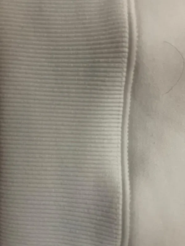 Close-up of the dense rib and clean stitching on the Sportlux Plus cream fleece hoodie