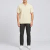 Full length view of the Sportlux Plus cream quarter zip polo worn with charcoal trousers and white trainers, showing the shirt length and fit on an average build