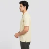 Side view of the Sportlux Plus cream quarter zip polo showing the 2 inch open side vent at the hem and the regular fit through the body