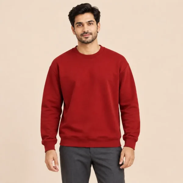 Man wearing the Sportlux Plus maroon crewneck sweatshirt with charcoal trousers, regular fit, front view