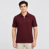 Man wearing a Sportlux Plus maroon quarter zip polo in fine cotton pique, front view, silver metal zip and red embroidered S on the left chest