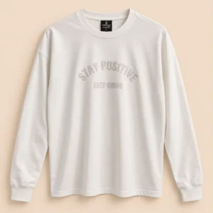 Sportlux Plus off-white oversized full sleeve t-shirt with tonal STAY POSITIVE KEEP GOING chest print, drop shoulder, rib collar and cuffs, flat lay